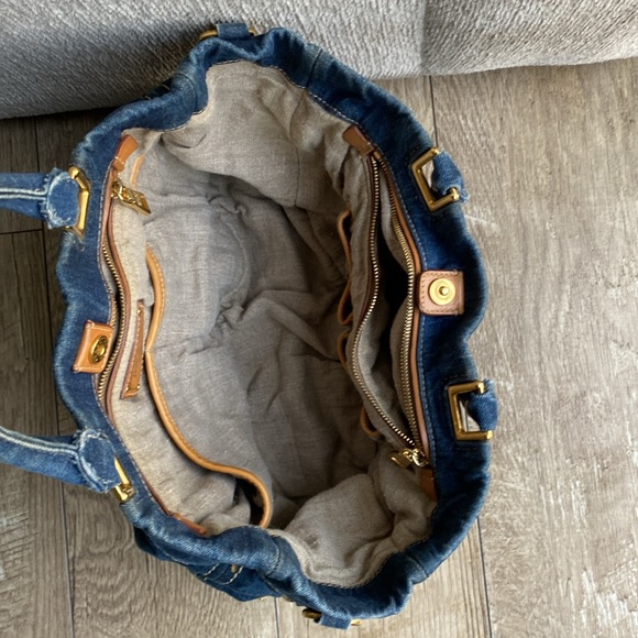 This is a Prada denim tote bag. No rips or tears, just minor wear from use. - Picture 6 of 9